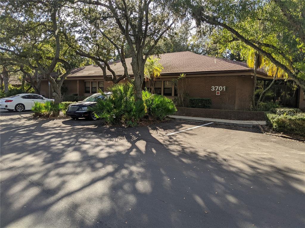 A single-story brick office building with a parking lot and mature trees in front — 3653 CORTEZ ROAD W UNIT 110, BRADENTON, FL