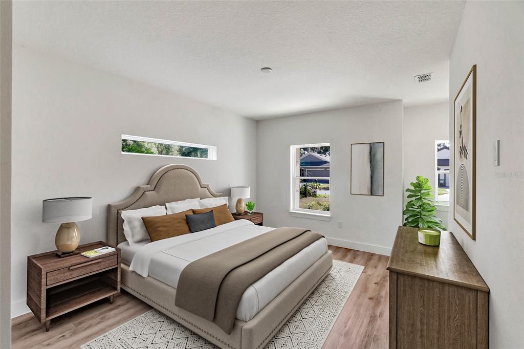 A bedroom features a beige upholstered bed, two nightstands, a dresser, and neutral decor — Lot #21 KAROLINA AVE, WINTER PARK, FL