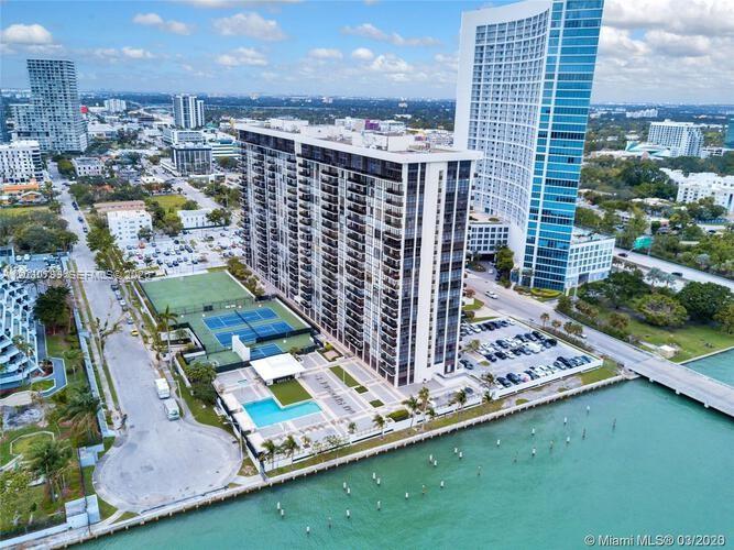 An aerial view shows a high-rise residential building with a pool and tennis courts — 600 NE 36th St # 417, Miami FL 33137, MIAMI, FL