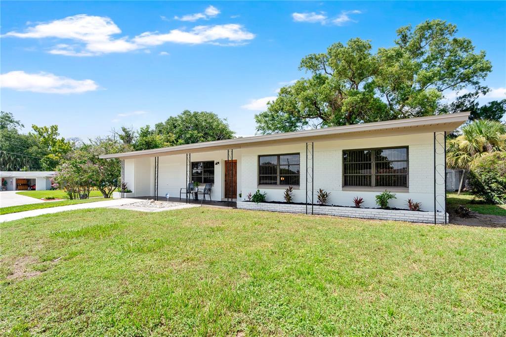 A white, single-story ranch-style house with a flat roof and a front lawn — 5301 BRERETON AVENUE, ORLANDO, FL