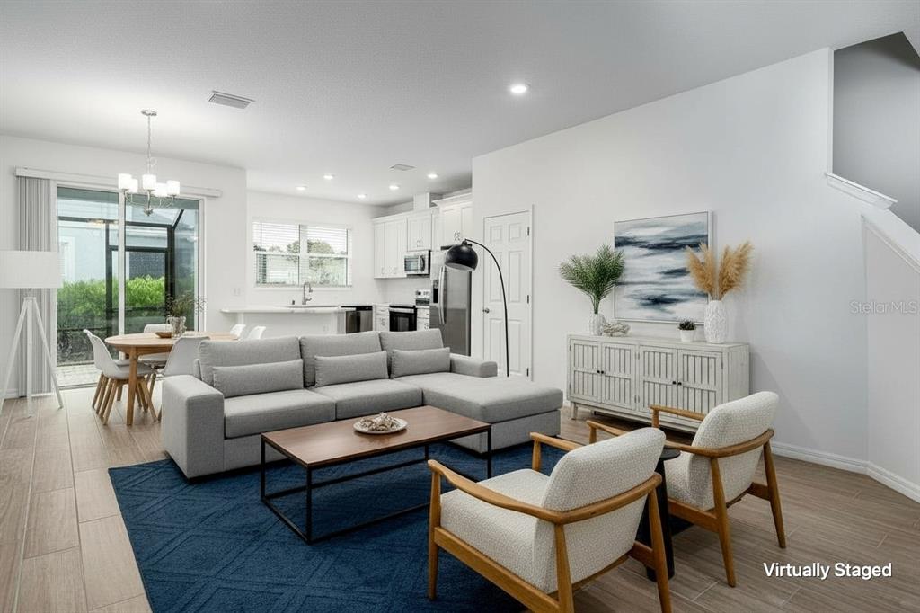 A modern kitchen features white cabinetry, stainless steel appliances, and a white marble-look countertop — 254 VIA ANINA DRIVE, SARASOTA, FL