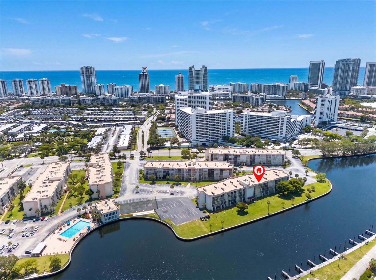 An aerial view shows a multi-story apartment building complex situated along a waterfront — 601 Three Islands Blvd # 403, Hallandale Beach FL 33009, HALLANDALE BEACH, FL