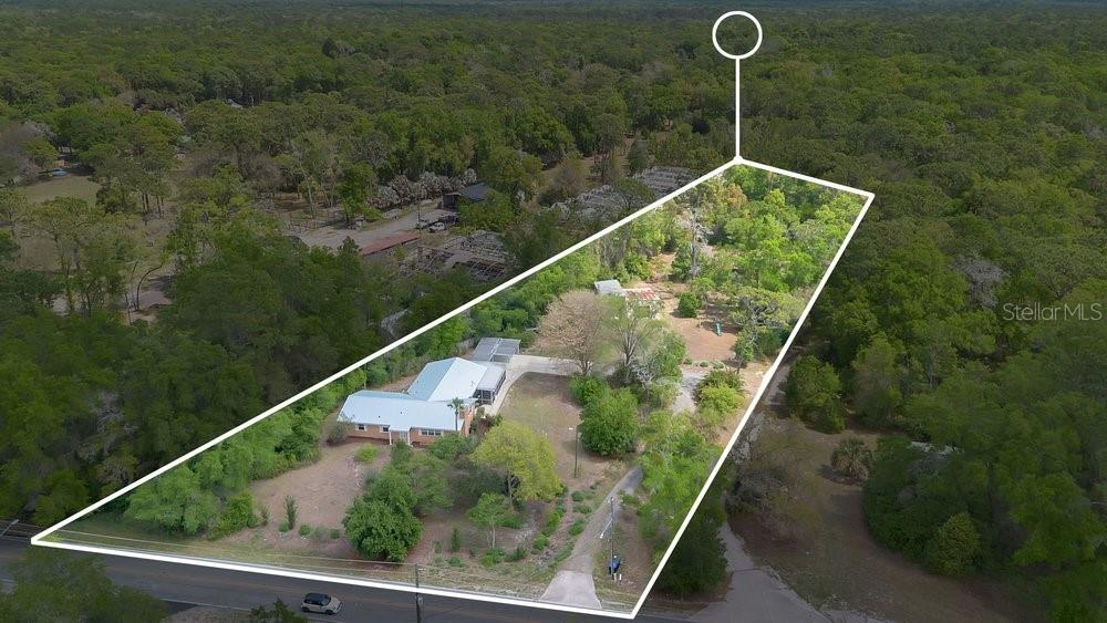 An aerial view shows a house on a large, wooded lot with a marked boundary — 5137 MOUNT PLYMOUTH ROAD, APOPKA, FL