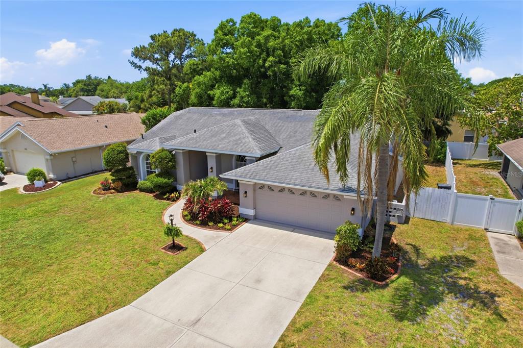 An aerial view of a single-story suburban house with a gray roof and driveway — 6130 55TH AVENUE CIRCLE E, BRADENTON, FL