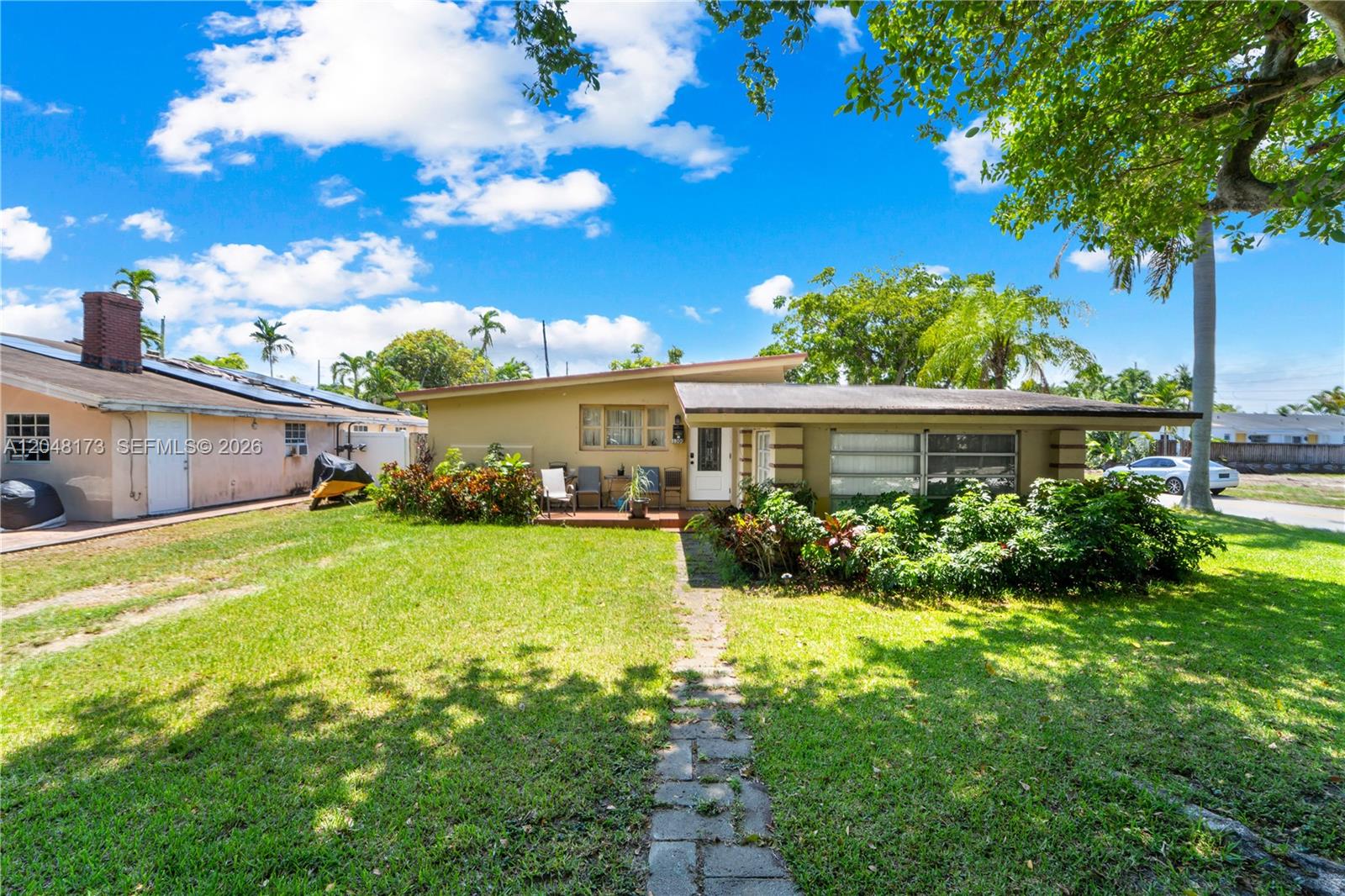 A single-story house with a flat roof, a stone walkway, and a grassy front yard — 1300 S 20th Ave, Hollywood FL 33020, HOLLYWOOD, FL