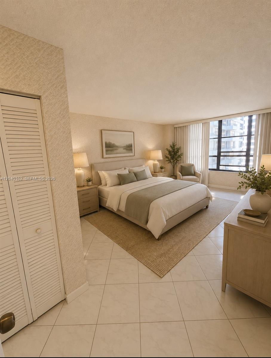 A bedroom features a bed, two nightstands, a dresser, and a window with city views — 600 Three Islands Blvd # 1015, Hallandale Beach FL 33009, HALLANDALE BEACH, FL