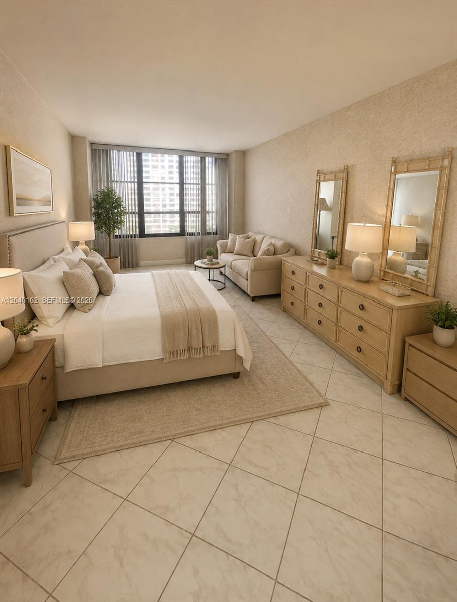 A bedroom features a bed, a sofa, a dresser with mirrors, and tile flooring — 600 Three Islands Blvd # 1015, Hallandale Beach FL 33009, HALLANDALE BEACH, FL