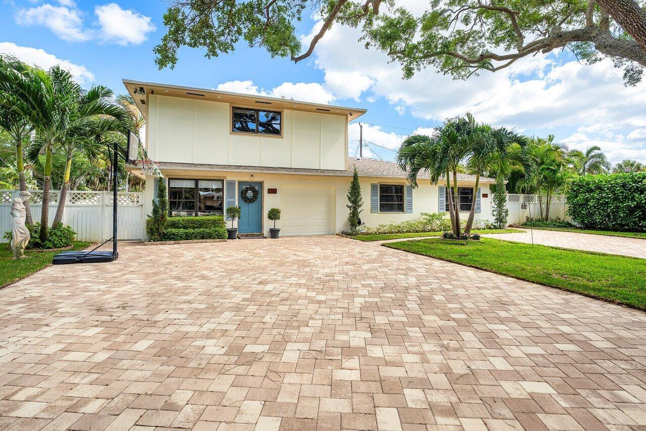 A two-story house with a paved driveway, palm trees, and a basketball hoop — 2101 N Palm Circle, North Palm Beach FL 33408, NORTH PALM BEACH, FL