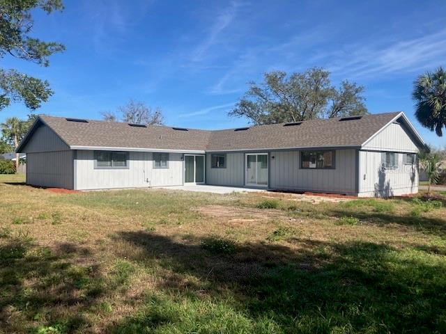 The exterior of a single-story house with gray vertical siding and a shingled roof — 5241 MAGNOLIA TERRACE, FRUITLAND PARK, FL