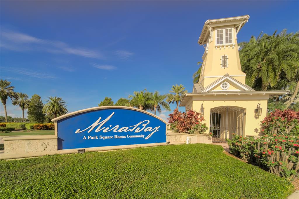 A living room with a sofa, two rattan chairs, and a rug on hardwood floors — 5713 SEA TROUT PLACE, APOLLO BEACH, FL