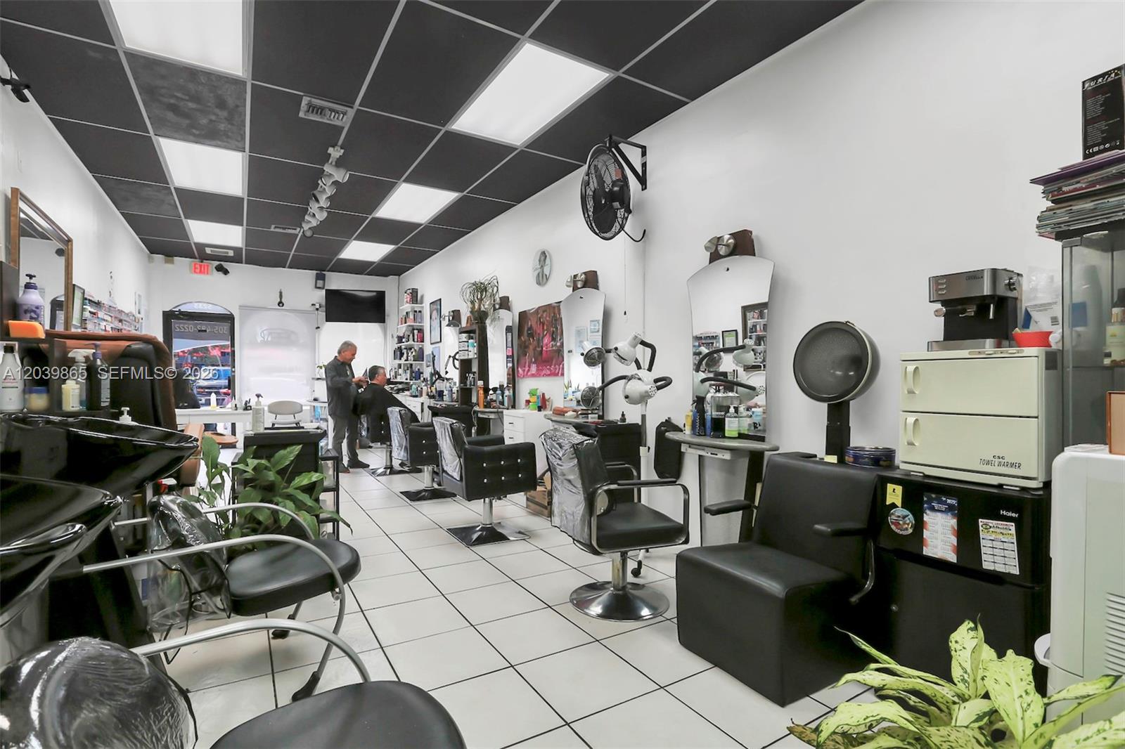 A hair salon interior features multiple styling chairs, mirrors, and a black drop ceiling — 5233 NW 79th Ave, Doral FL 33166, DORAL, FL