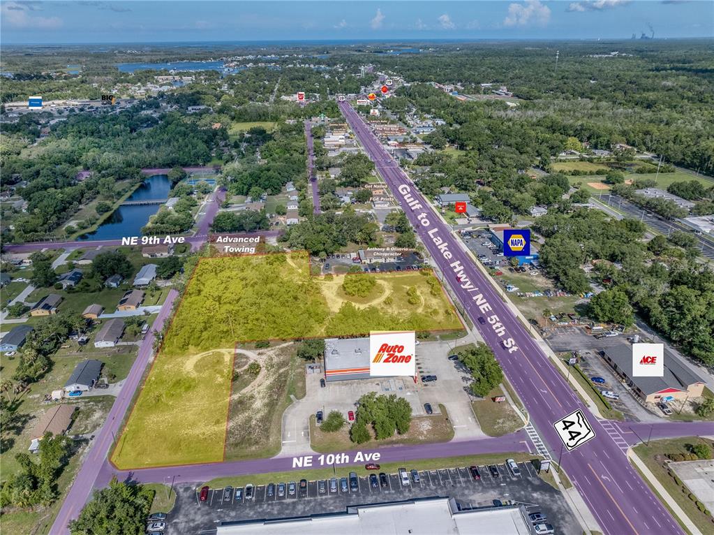 This aerial map shows a vacant, grass-covered lot bordered by commercial buildings and roadways — 950 NE 5TH STREET, CRYSTAL RIVER, FL