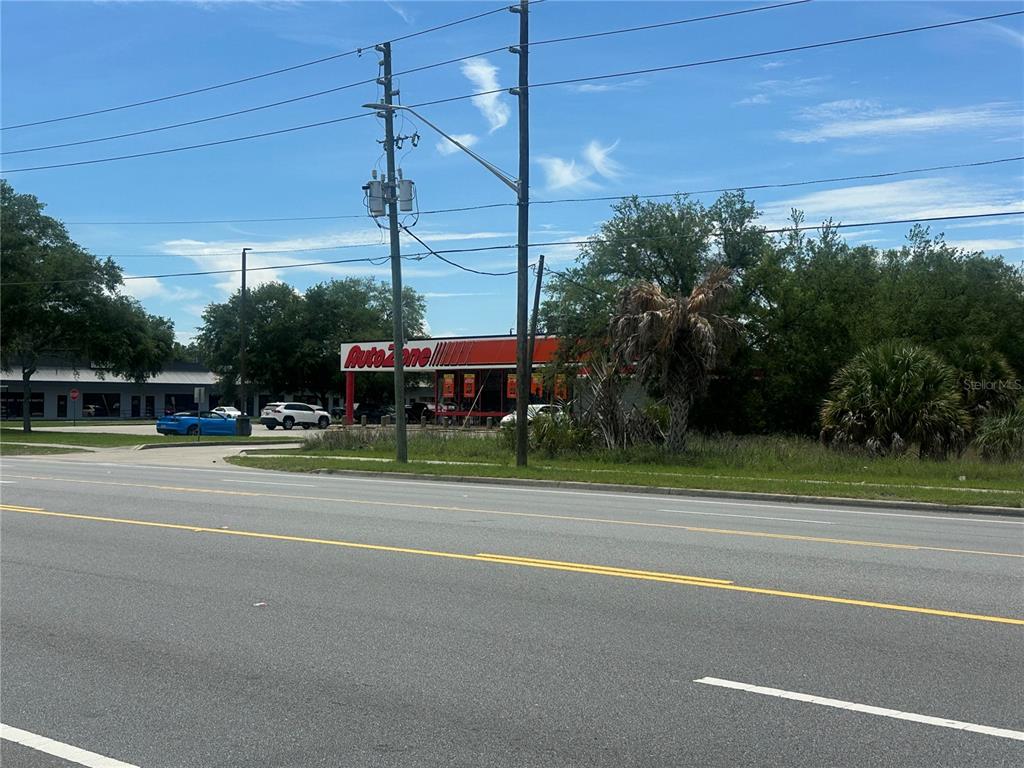 An AutoZone store is visible from across a multi-lane road with utility poles — 950 NE 5TH STREET, CRYSTAL RIVER, FL