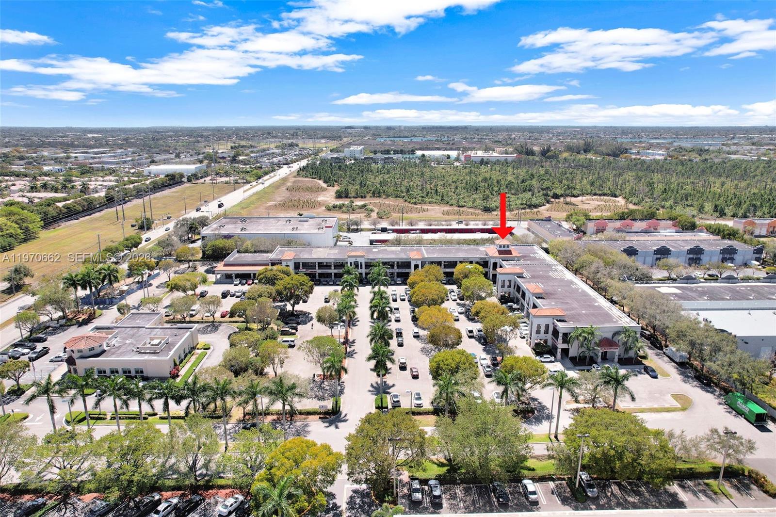 An aerial view shows a commercial office complex with parking lots and surrounding greenery — 12338 SW 127, Miami FL 33186, MIAMI, FL
