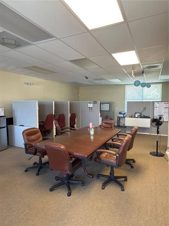 An office space features a large wooden conference table surrounded by brown leather chairs — 2563 N TOLEDO BLADE BOULEVARD UNIT 2, NORTH PORT, FL