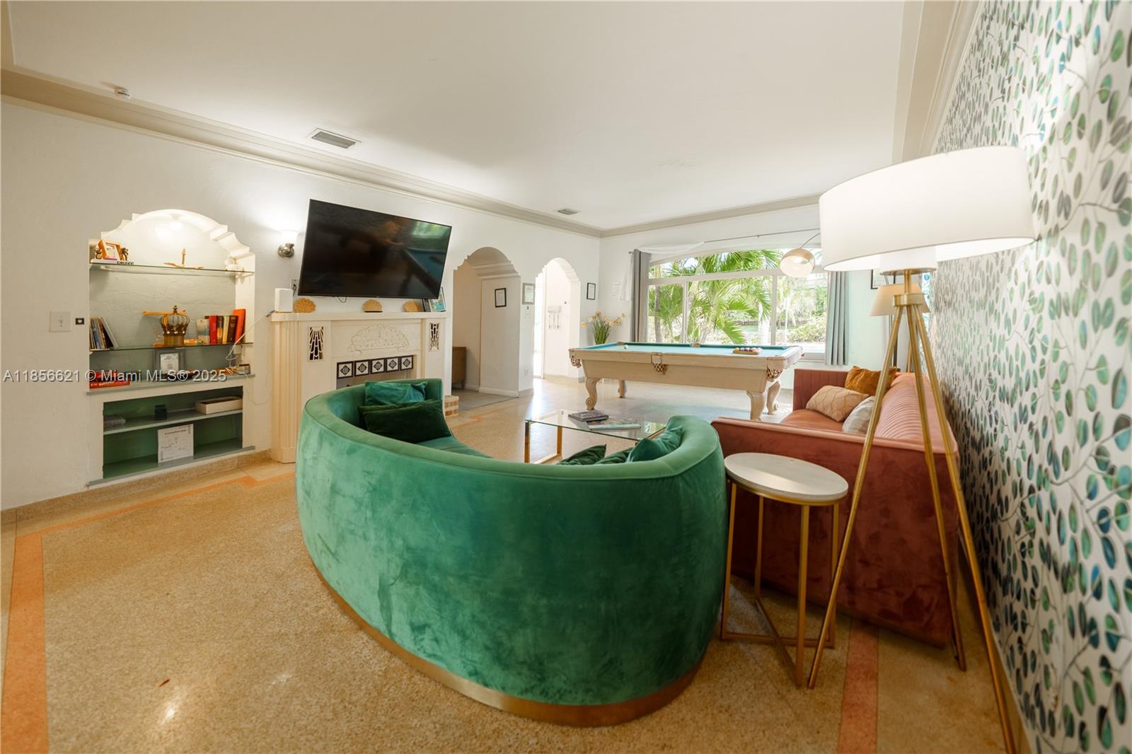A living room features a green curved sofa, a pink sofa, and a pool table — 701 Hollywood Blvd # 701, Hollywood FL 33019, HOLLYWOOD, FL