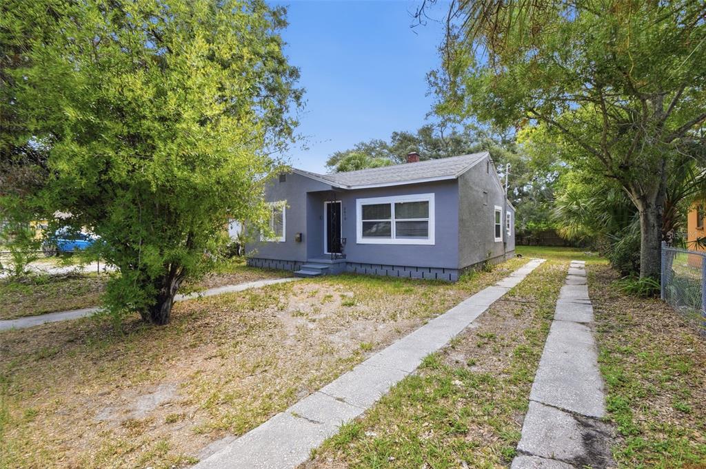 A gray, single-story house with a front-facing gable roof and a concrete driveway — 2610 DR MARTIN LUTHER KING JR STREET S, ST PETERSBURG, FL