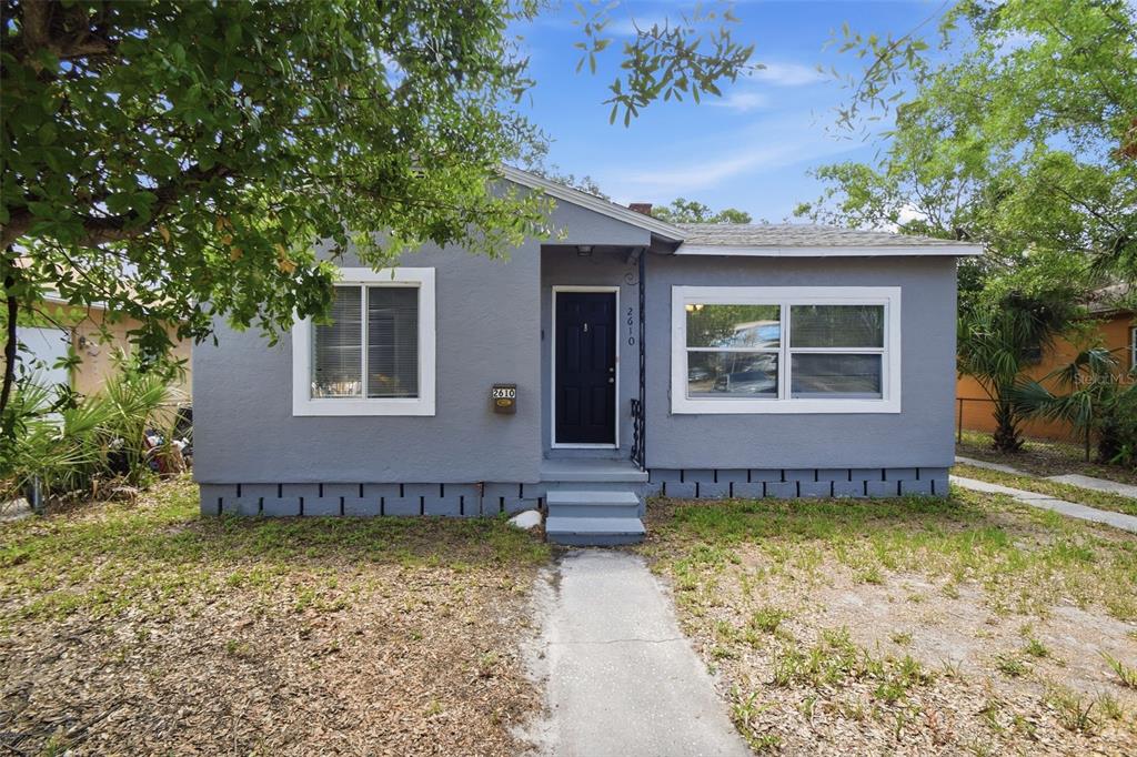 A single-story gray house with a black front door and white-trimmed windows — 2610 DR MARTIN LUTHER KING JR STREET S, ST PETERSBURG, FL