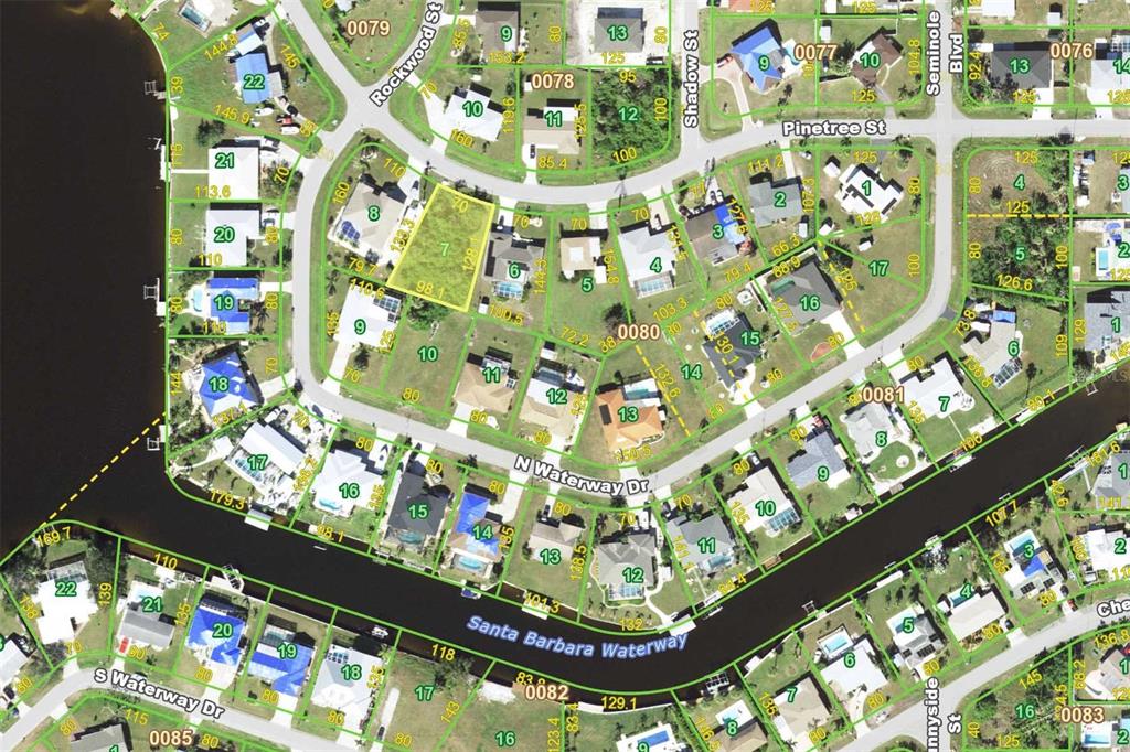 This is a satellite map showing residential lots and waterways in a suburban neighborhood — 3471 PINETREE STREET, PORT CHARLOTTE, FL