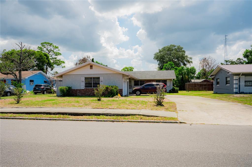 A single-story house with a light-colored exterior, a driveway, and a front lawn — 2705 SHERINGHAM ROAD UNIT 6, ORLANDO, FL