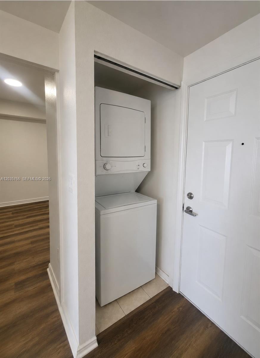 A stacked washer and dryer unit is located in a closet near an entry door — 120 SW 8th Ave # 502, Miami FL 33130, MIAMI, FL
