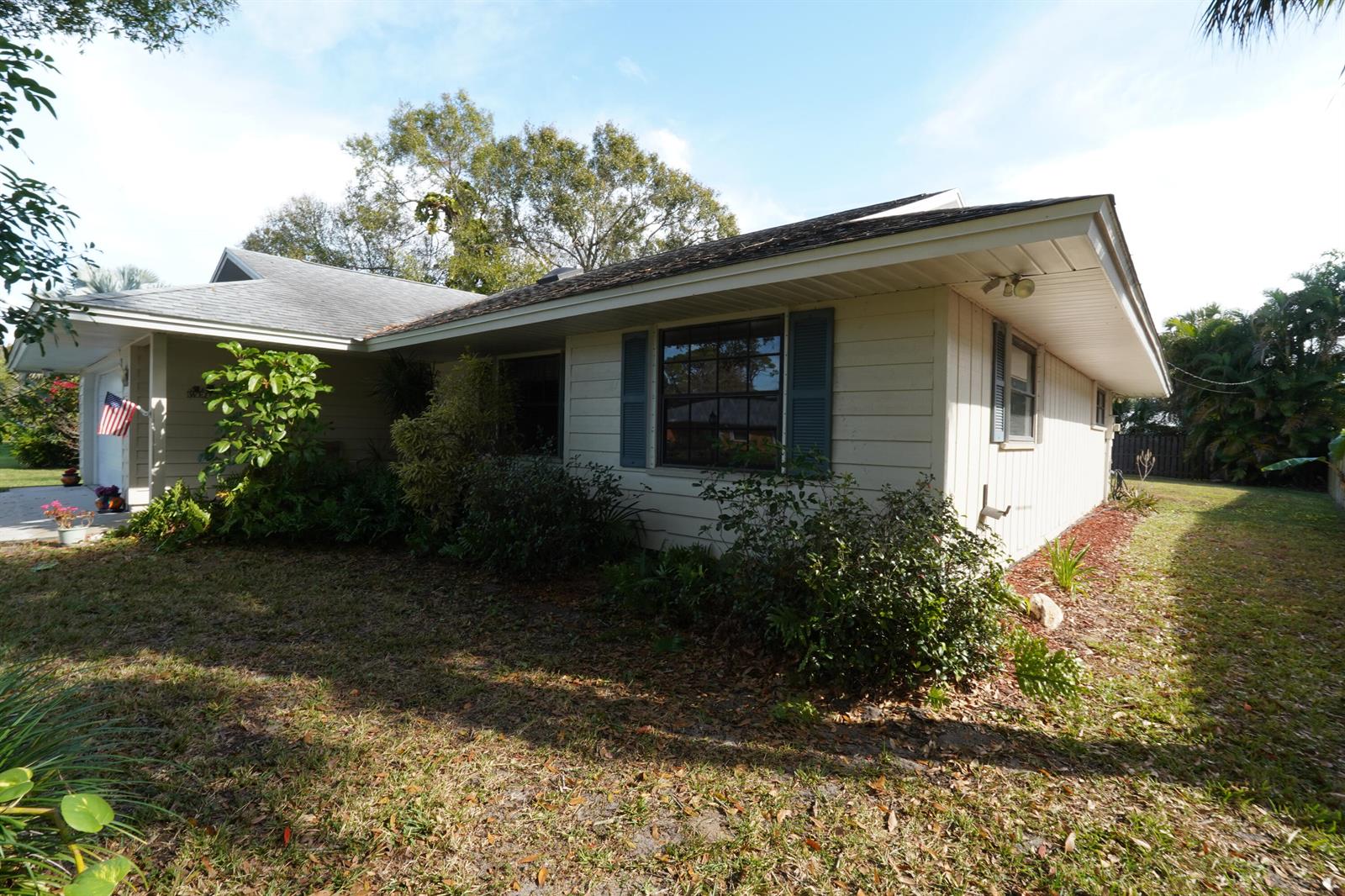 A single-story house with light-colored siding, a dark roof, and a front-facing garage — 166 23rd Avenue, Vero Beach FL 32962, VERO BEACH, FL