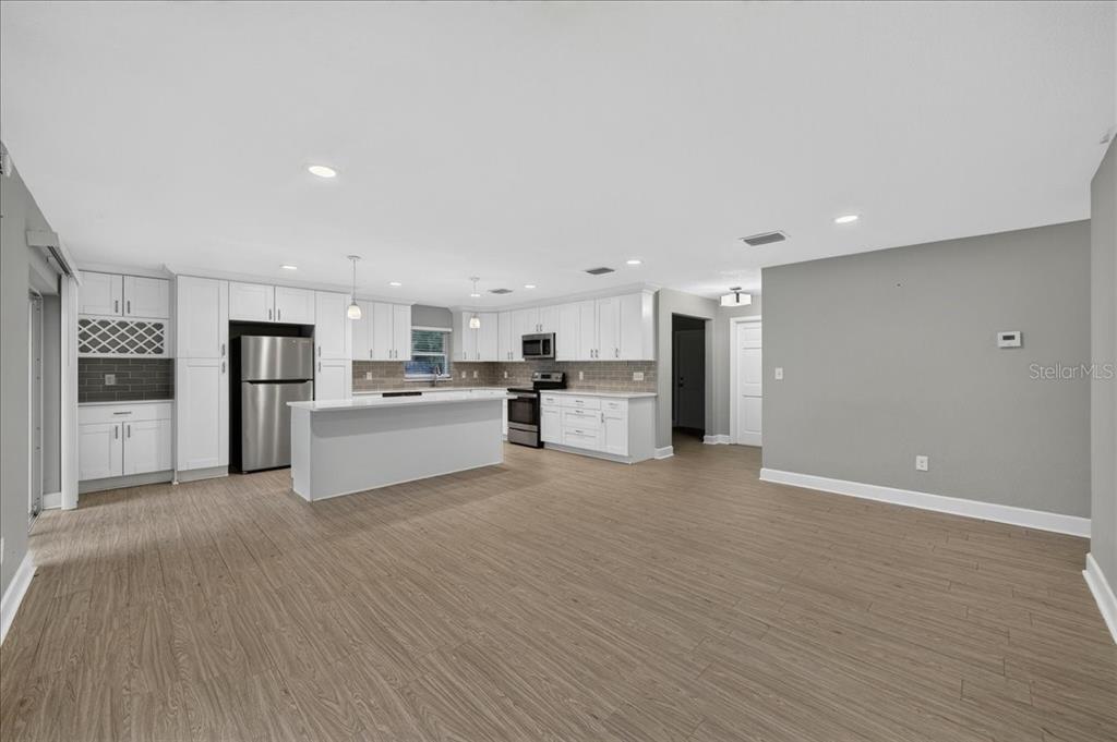 A dark front door is centered in a recessed entryway with textured stucco walls — 795 7TH STREET S, SAFETY HARBOR, FL