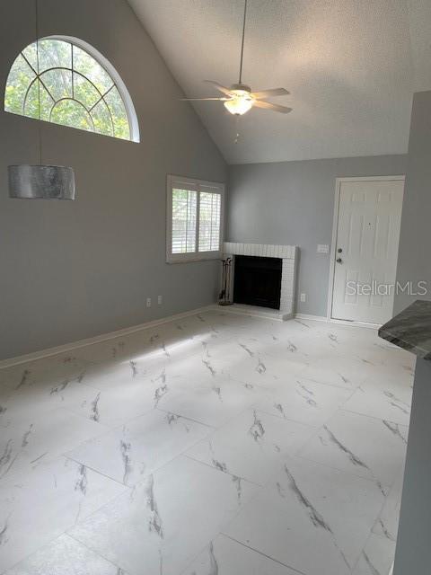 A living room with vaulted ceilings, a fireplace, and white marble-look tile flooring — 575 BLOOMINGTON COURT UNIT 20, ALTAMONTE SPRINGS, FL