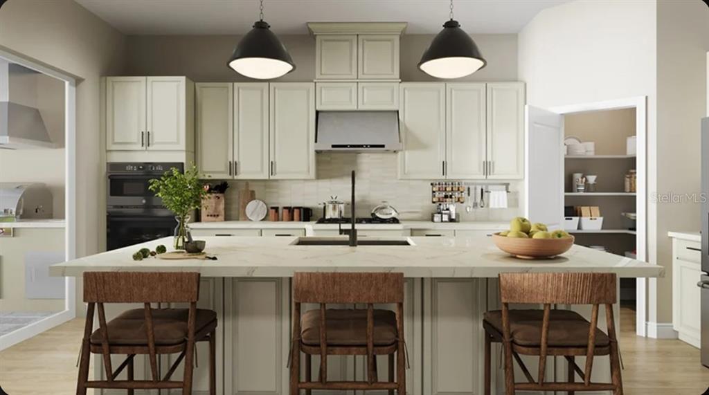This is a rendering of a kitchen featuring a large island, light cabinetry, and pendant lighting — 10581 ECLIPSE STREET, SARASOTA, FL
