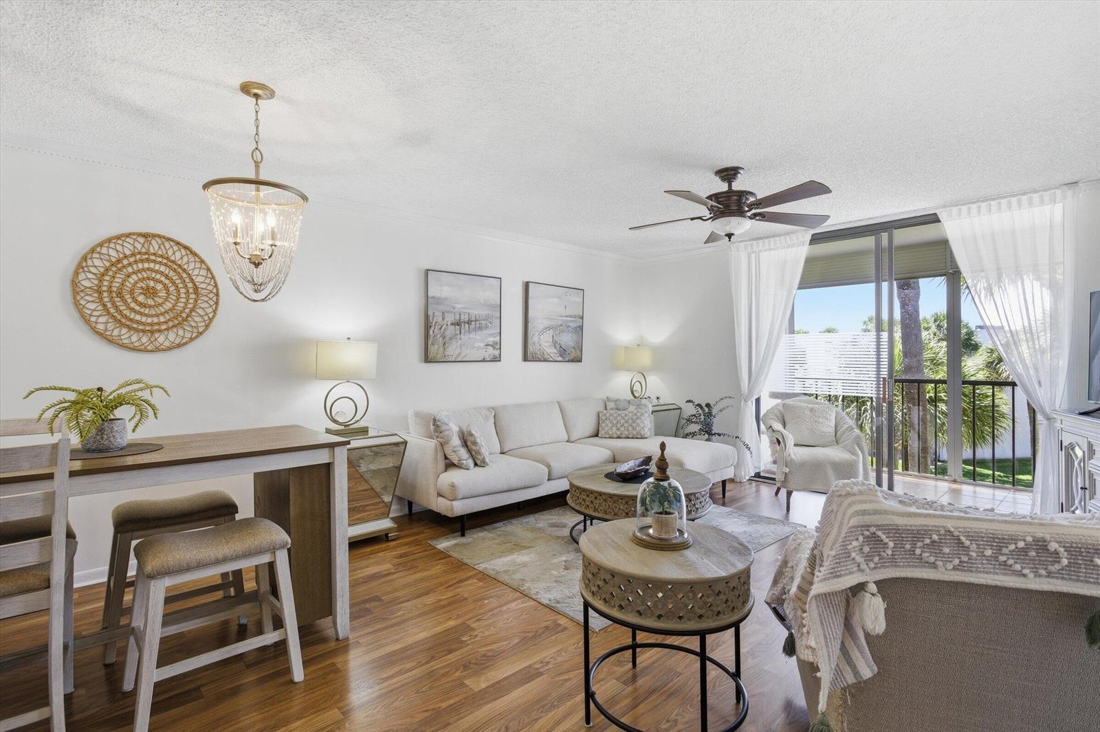 A living room features a sectional sofa, two round coffee tables, and a dining area — 5370 Las Verdes Circle # 303, Delray Beach FL 33484, DELRAY BEACH, FL