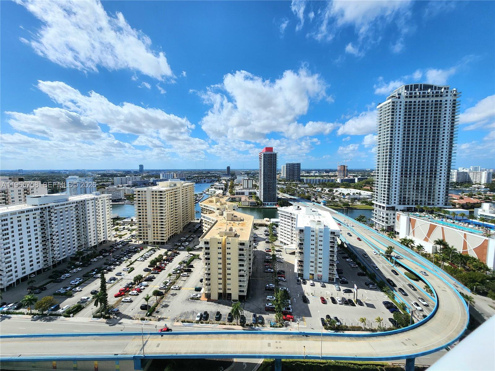 An elevated view shows a city skyline with high-rise buildings, parking lots, and a highway — 1800 S Ocean Dr # 2406, Hallandale Beach FL 33009, HALLANDALE BEACH, FL