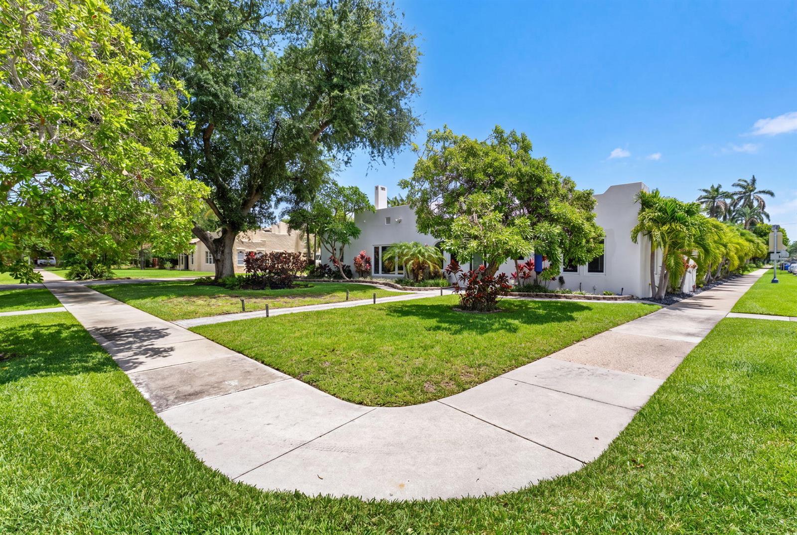 A white, single-story house with a lawn and sidewalk sits under a clear blue sky — 400 NE 5th Avenue, Pompano Beach FL 33060, POMPANO BEACH, FL