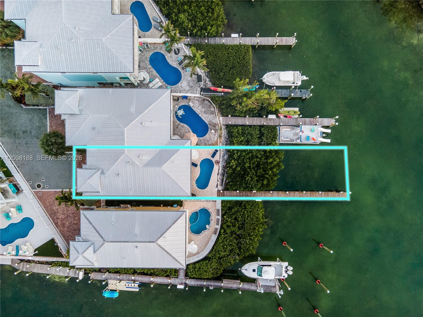 An aerial view shows a waterfront house with a swimming pool and a private dock — 443 Sombrero Beach Rd, Marathon FL 33050, MARATHON, FL
