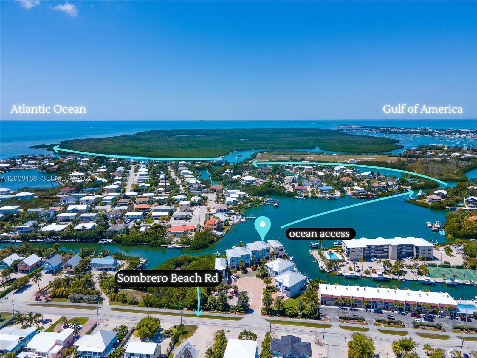 This aerial view shows a coastal residential area with a canal and ocean access — 443 Sombrero Beach Rd, Marathon FL 33050, MARATHON, FL