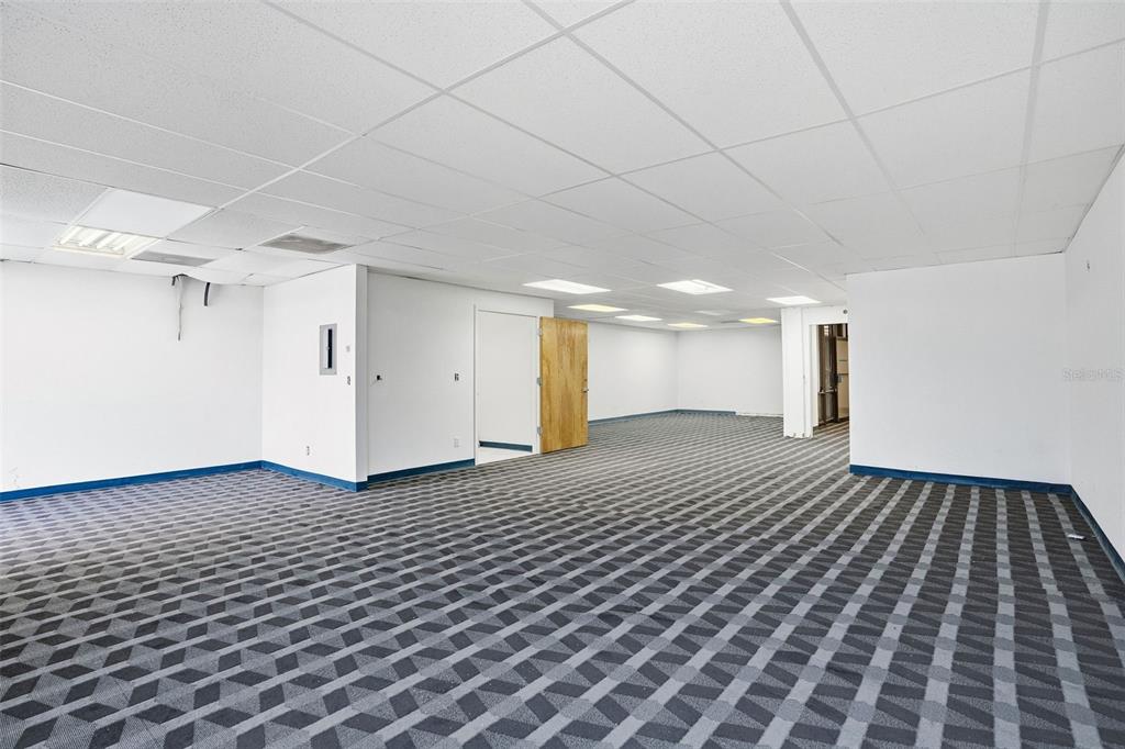 An empty office space features white walls, a drop ceiling, and patterned gray carpet — 5341 GRAND BOULEVARD UNIT 103, NEW PORT RICHEY, FL