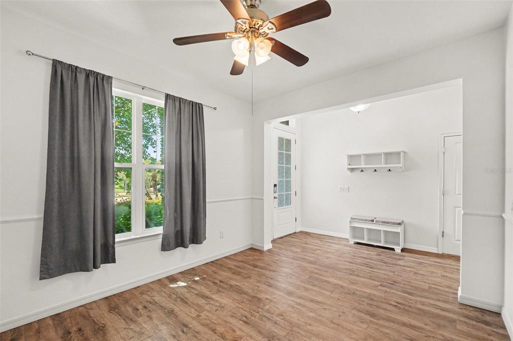 A kitchen with dark cabinets, granite countertops, a central island, and stairs in the background — 12324 STREAMBED DRIVE, RIVERVIEW, FL