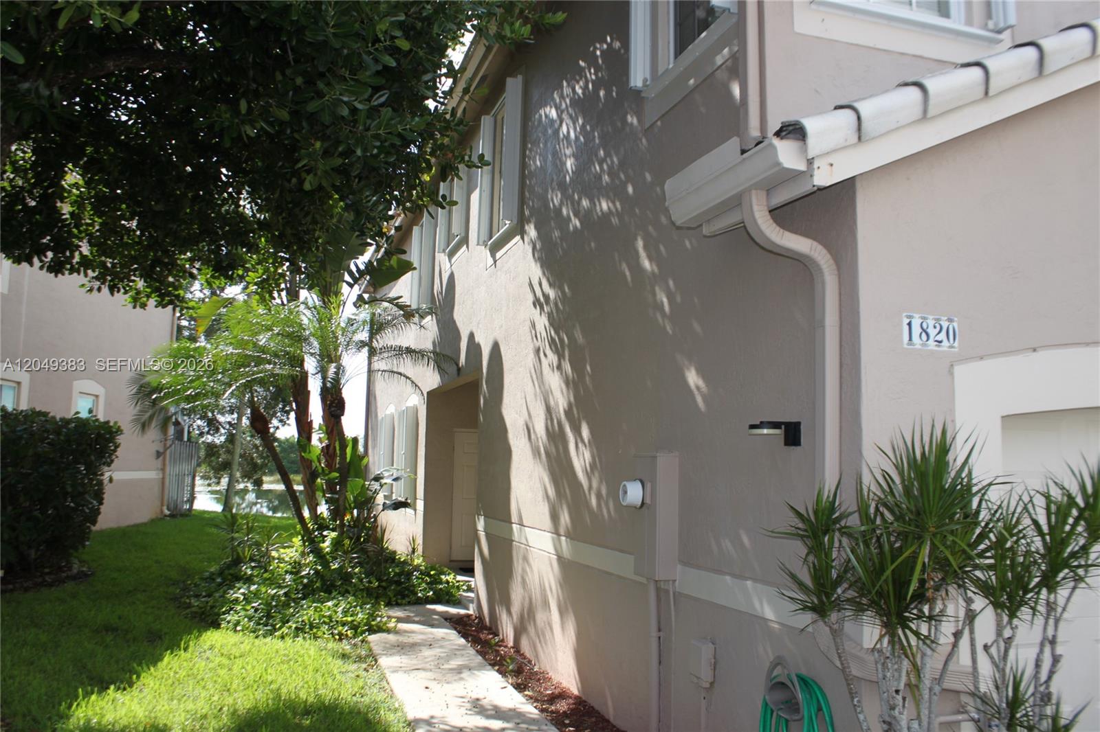 A kitchen features light-colored cabinets, stainless steel appliances, and white countertops with marble veining — 1820 Salerno Cir, Weston FL 33327, WESTON, FL