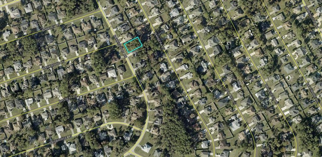 An aerial view shows a vacant, rectangular residential lot highlighted in a suburban neighborhood — 76 BARRINGTON DRIVE, PALM COAST, FL