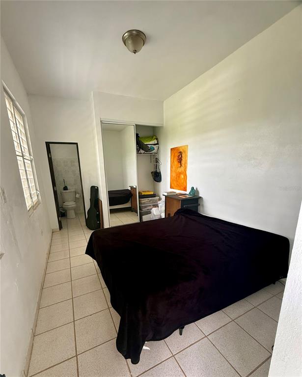 A kitchen features white cabinets, a stainless steel stove, a refrigerator, and a breakfast bar — 181 ROUTE, YABUCOA, PR
