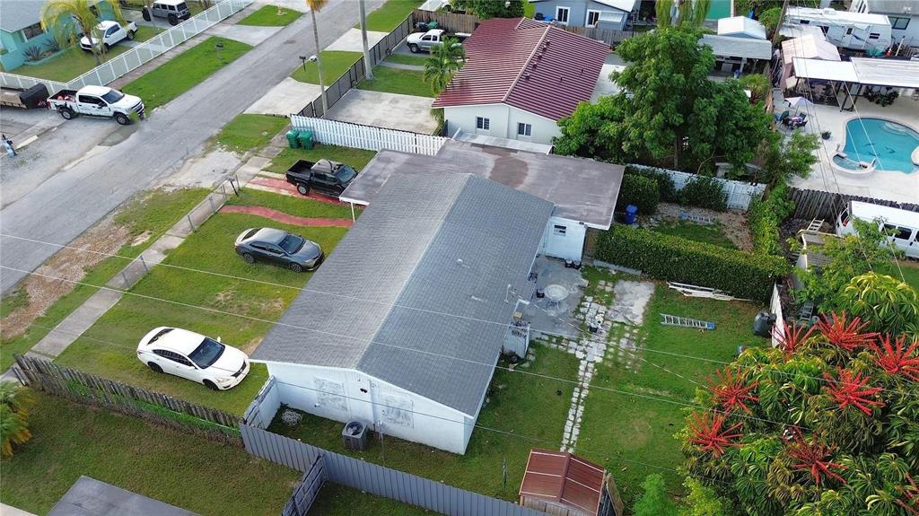 An aerial view shows a residential house with a gray roof and a backyard — 30081 SW 148TH AVENUE, HOMESTEAD, FL