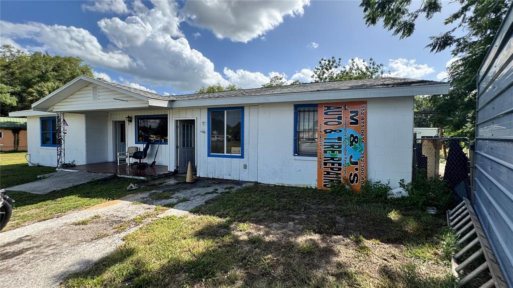 A single-story white building with a sign for an auto repair shop on the exterior — 5050 S PINE AVENUE, OCALA, FL