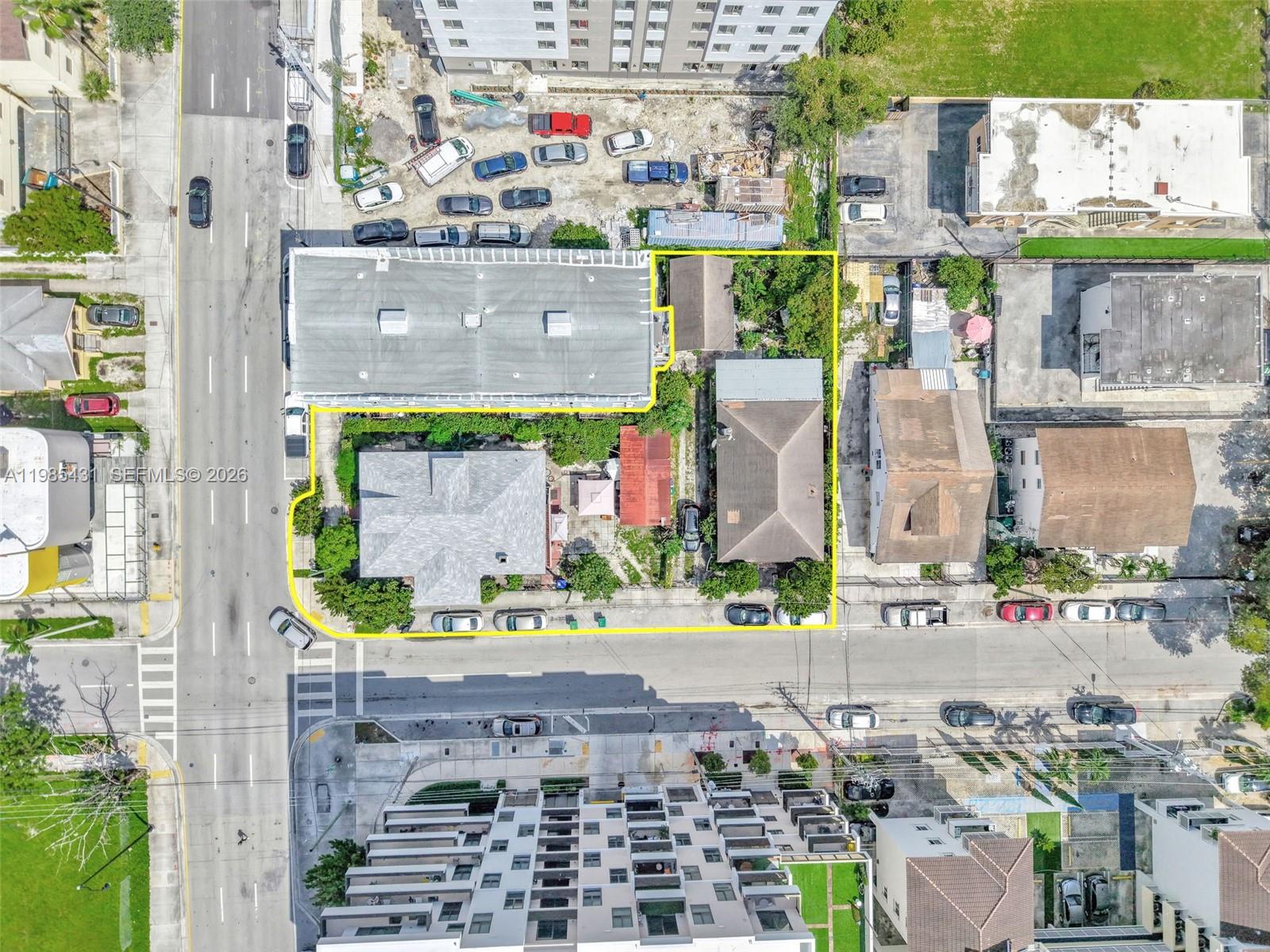 Aerial view of a residential property lot outlined in yellow within a dense urban neighborhood — 119 SW 7th Ave, Miami FL 33130, MIAMI, FL