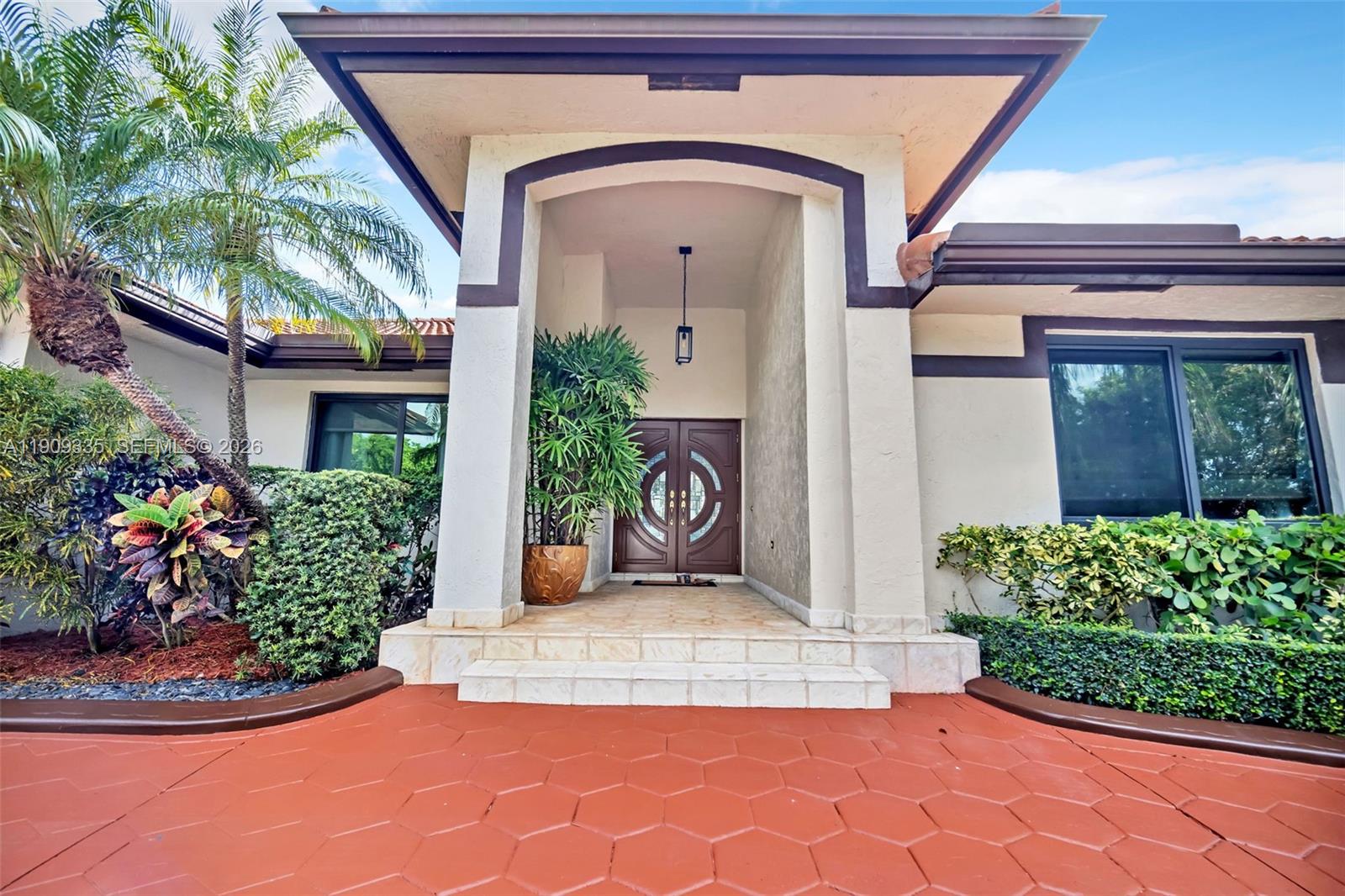 The exterior features a covered entryway with double doors, tiled steps, and a paved driveway — 15462 SW 115th St, Miami FL 33196, MIAMI, FL