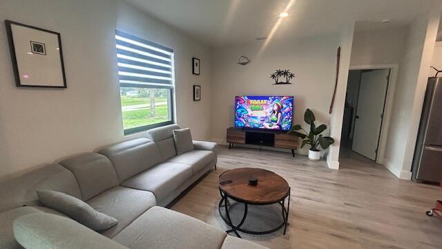 A living room with a gray sectional sofa, a round coffee table, and a television — 1151 Jabara Circle, FL 33935, FL