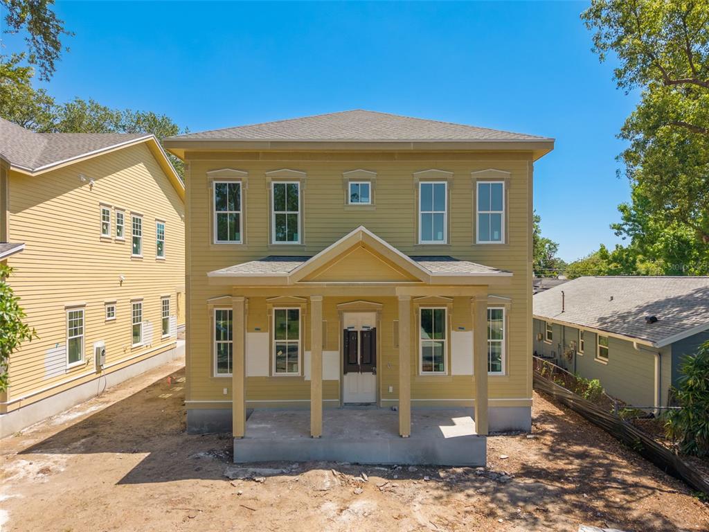 A two-story yellow house with a front porch and a concrete foundation under construction — 5326 7TH AVENUE N, ST PETERSBURG, FL