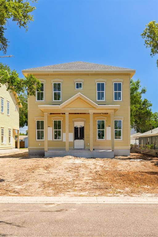 A two-story, yellow-sided house under construction with a front porch and unfinished yard — 5326 7TH AVENUE N, ST PETERSBURG, FL