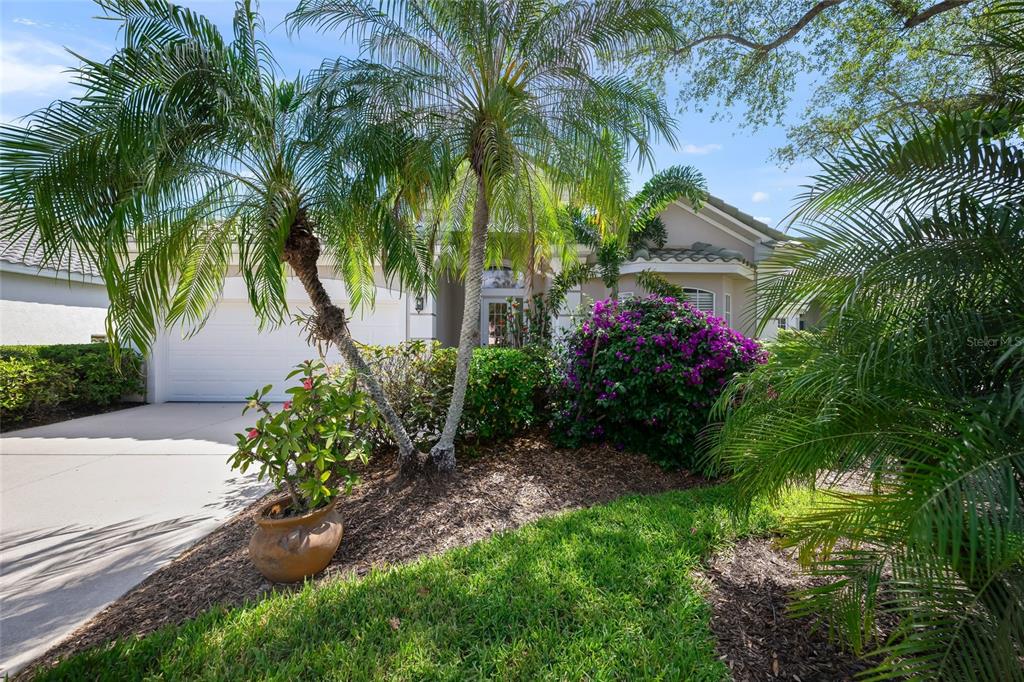 A living room features green leather recliners, white armchairs, a television, and tile flooring — 6923 LENNOX PLACE, UNIVERSITY PARK, FL