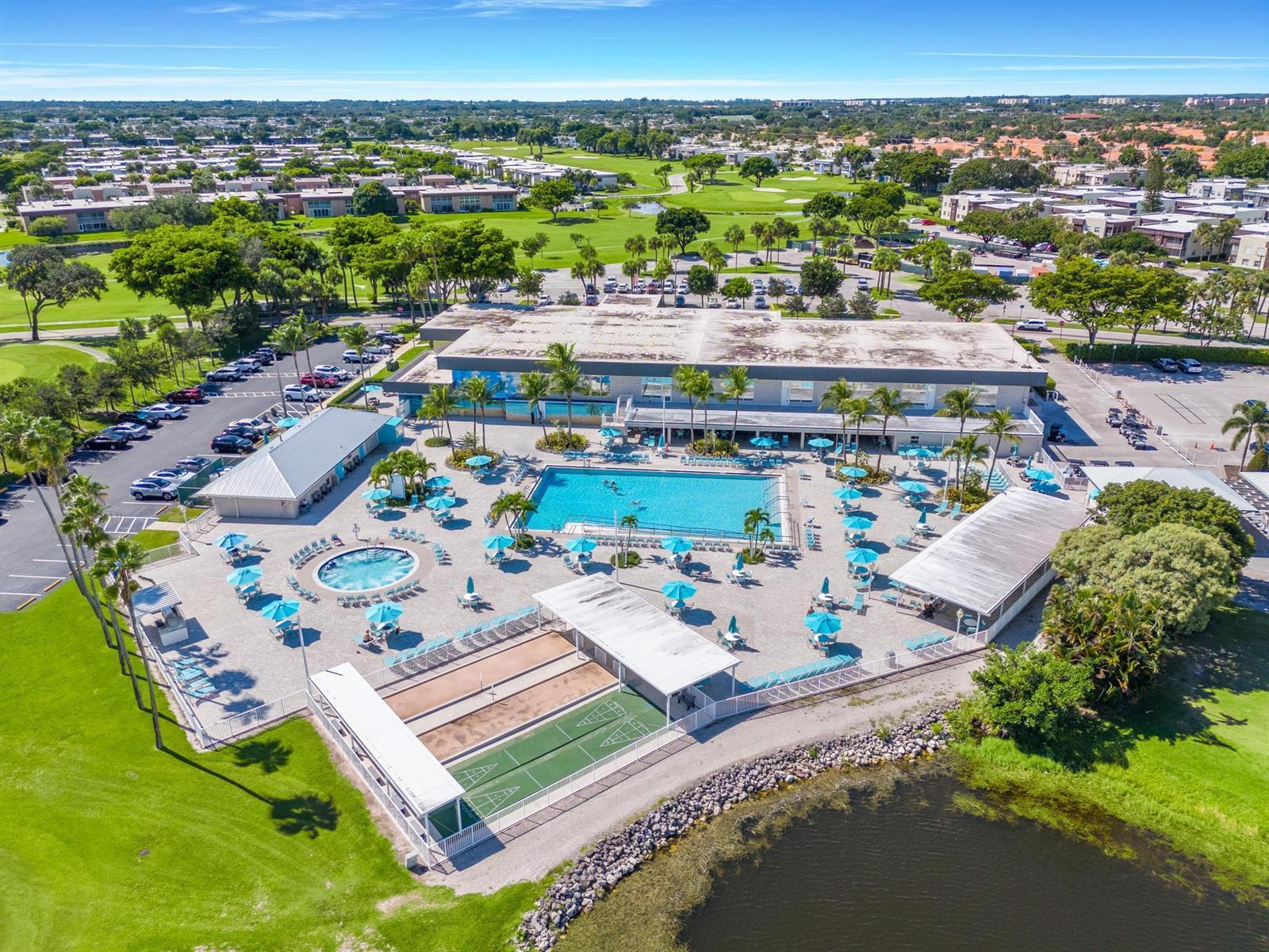 An aerial view shows a community pool area with a clubhouse, shuffleboard courts, and parking — 362 Burgundy H, Delray Beach FL 33484, DELRAY BEACH, FL
