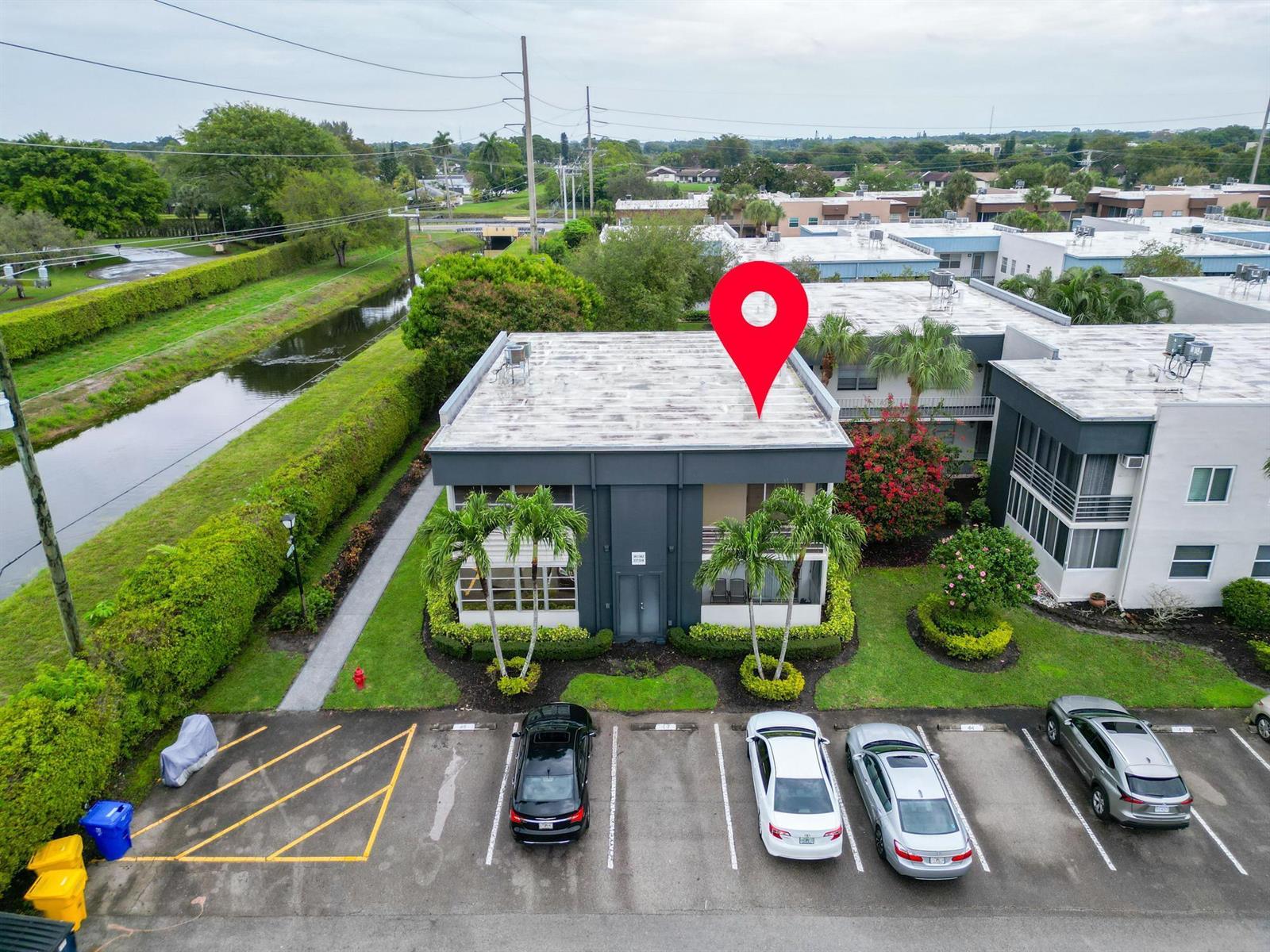 An aerial view shows a two-story apartment building with a flat roof and parking lot — 362 Burgundy H, Delray Beach FL 33484, DELRAY BEACH, FL