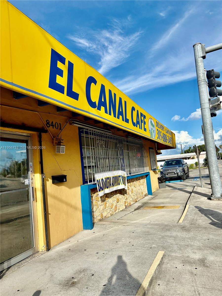 A yellow exterior of a commercial building with a sign reading El Canal Cafe — 8401 NW South River Dr, Medley FL 33166, MEDLEY, FL